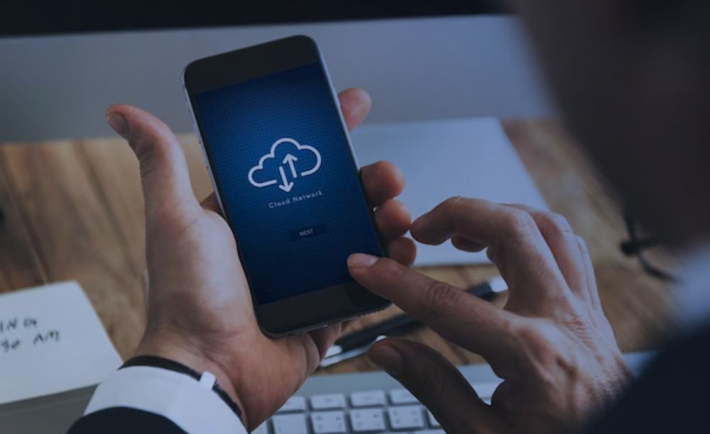 Closeup of businessman using smartphone with cloud computing symbol