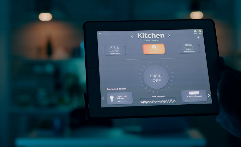 tablet with active smart home application holded by man